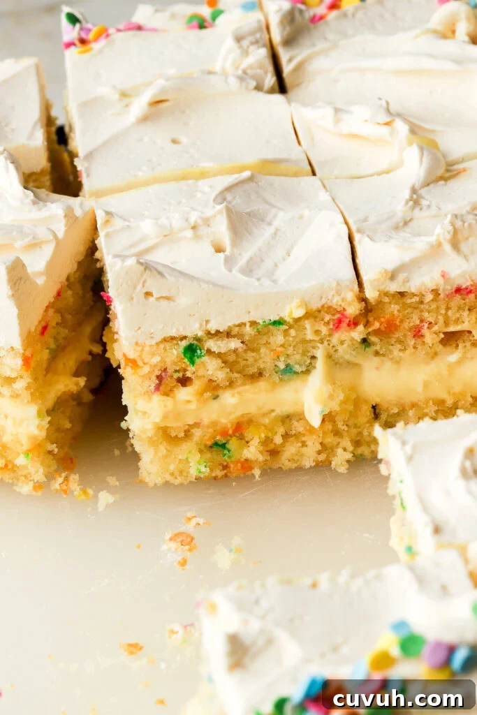 Party-Size Vanilla Birthday Sheet Cake Recipe 27 birthday cake on a board with slices cut to show the inside