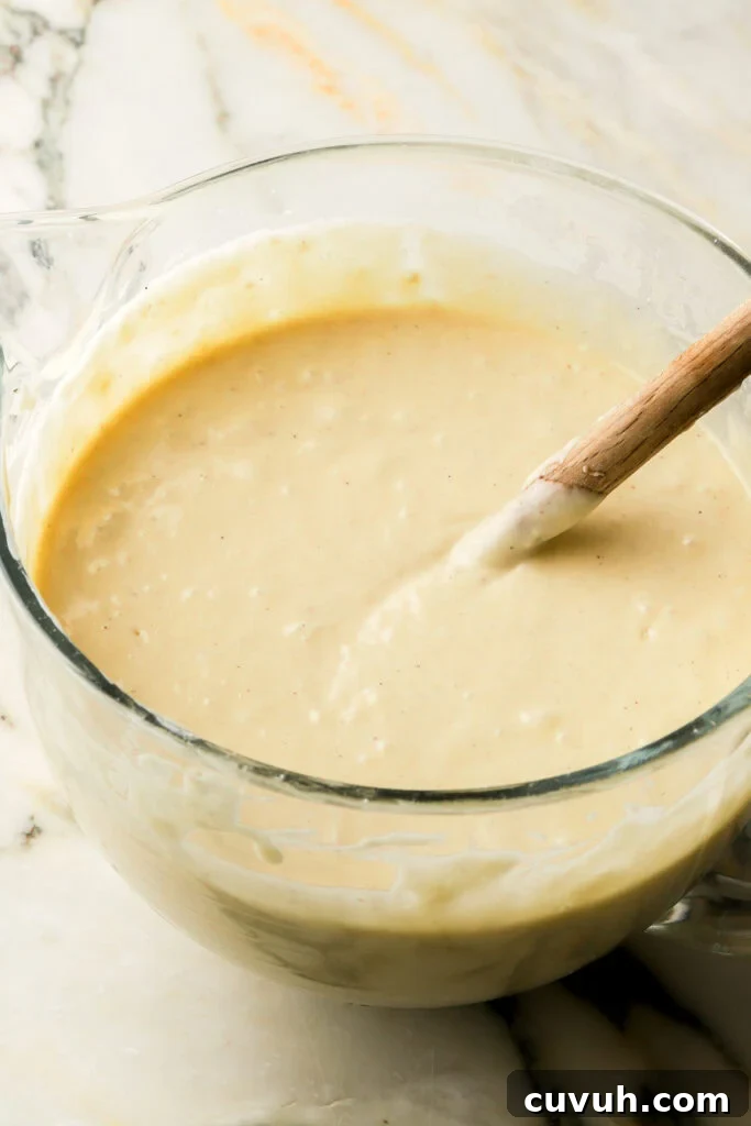Party-Size Vanilla Birthday Sheet Cake Recipe 9 finished cake batter in a glass bowl with spatula in bowl