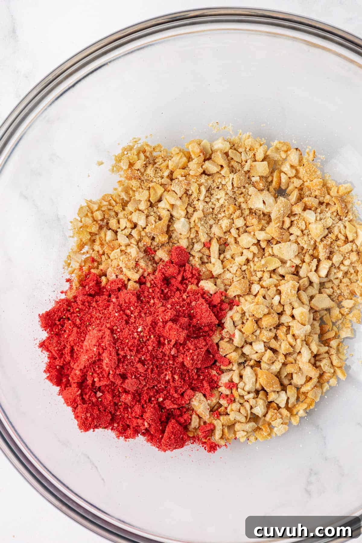 pulsed cashews and crushed freeze dried strawberries in a bowl