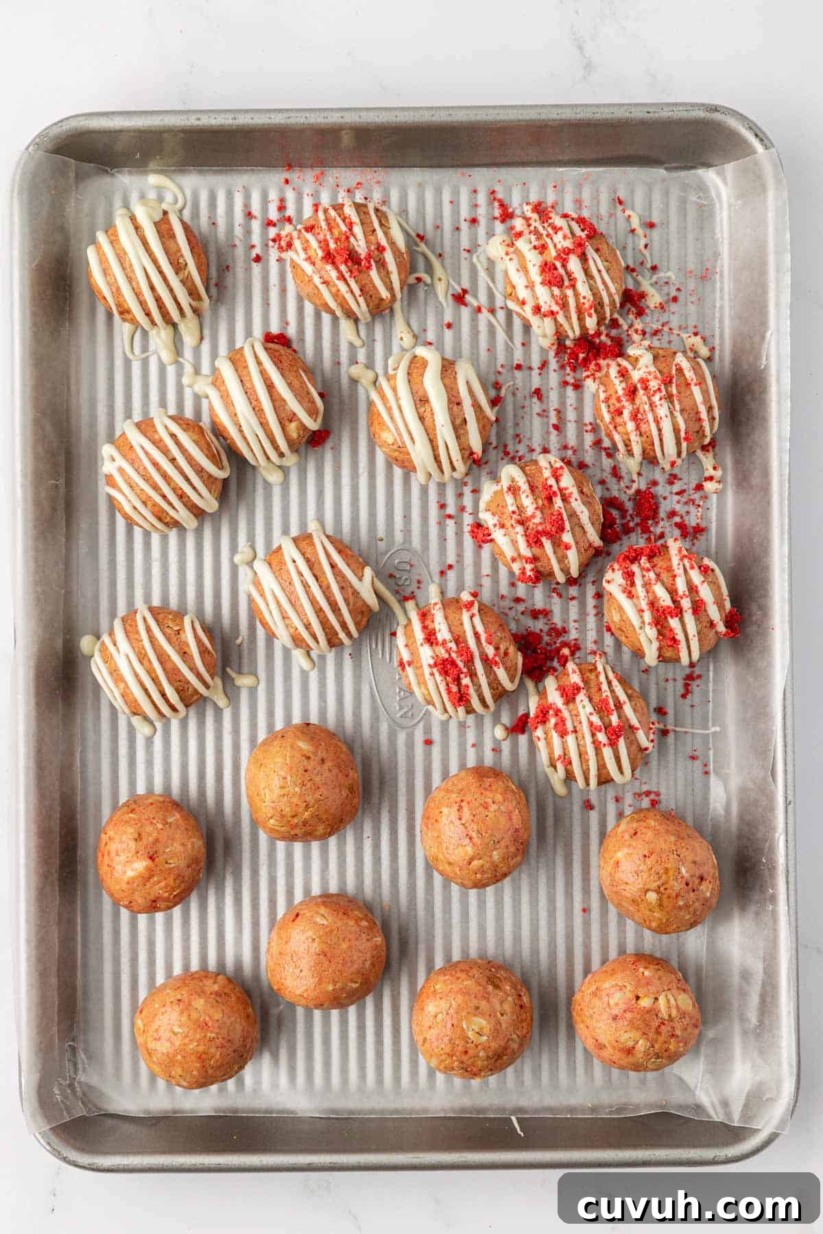 strawberries and cream energy bites on a baking sheet