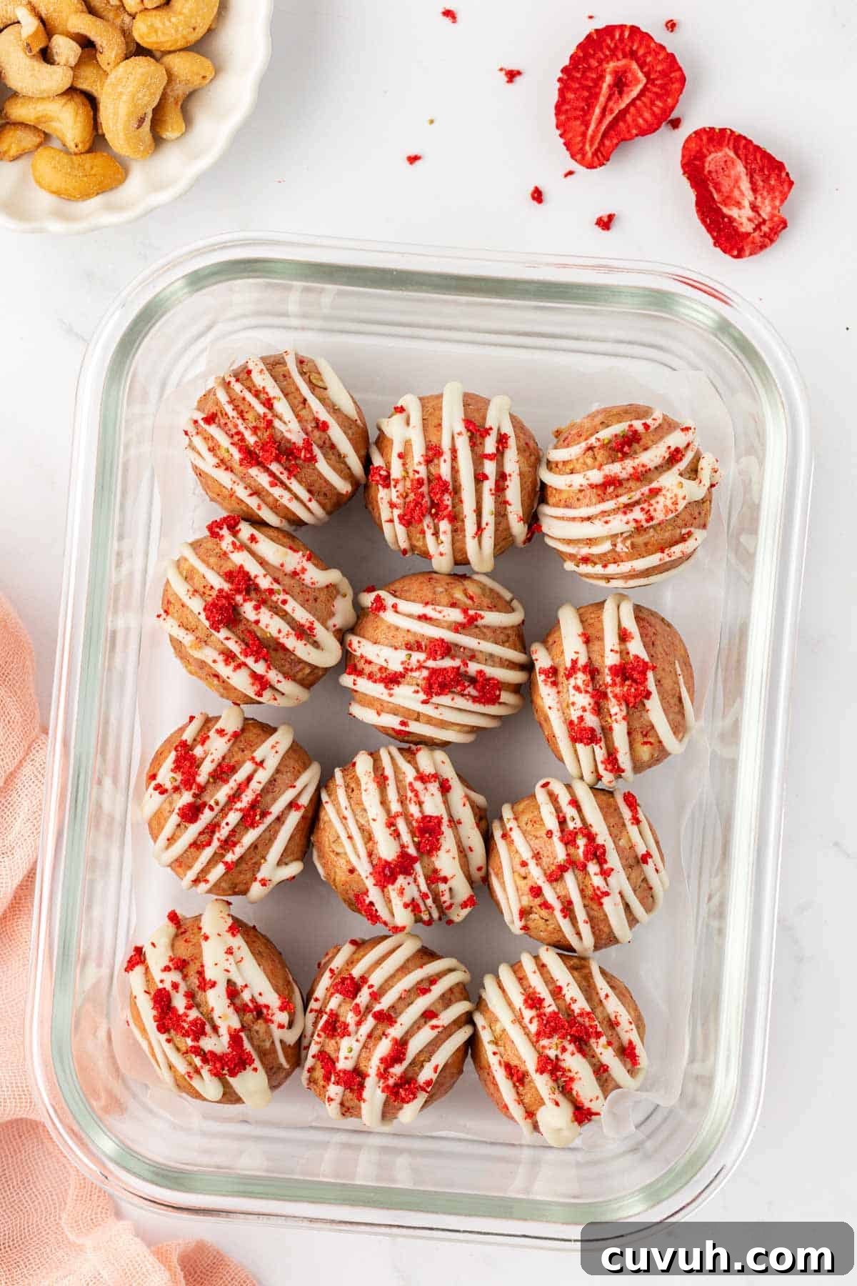 strawberries and cream energy bites in a storage container