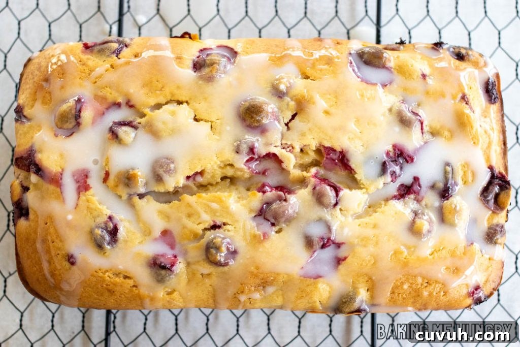 glaze topped cranberry cream cheese bread on wire rack