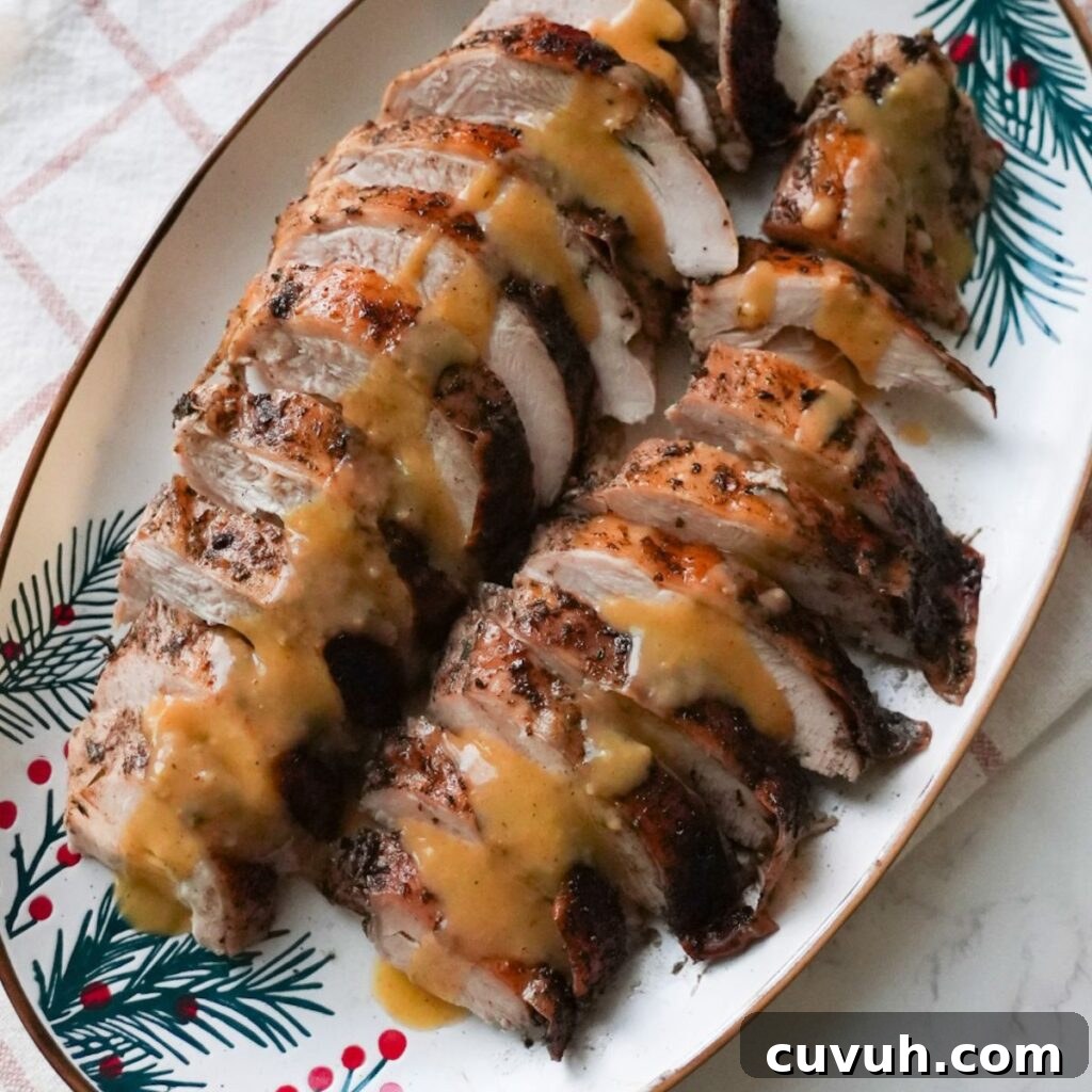 Jerk Turkey Breast Recipe: Spicy Caribbean-Rubbed Roasted Turkey 2 Roasted jerk turkey breast sliced on a plate with gravy.