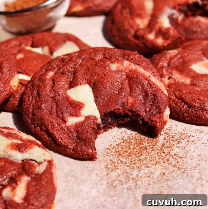 Decadent Red Velvet Cookies Recipe for Perfect Soft-Chewy Treats 4 red velvet cookies with bite on baking sheet
