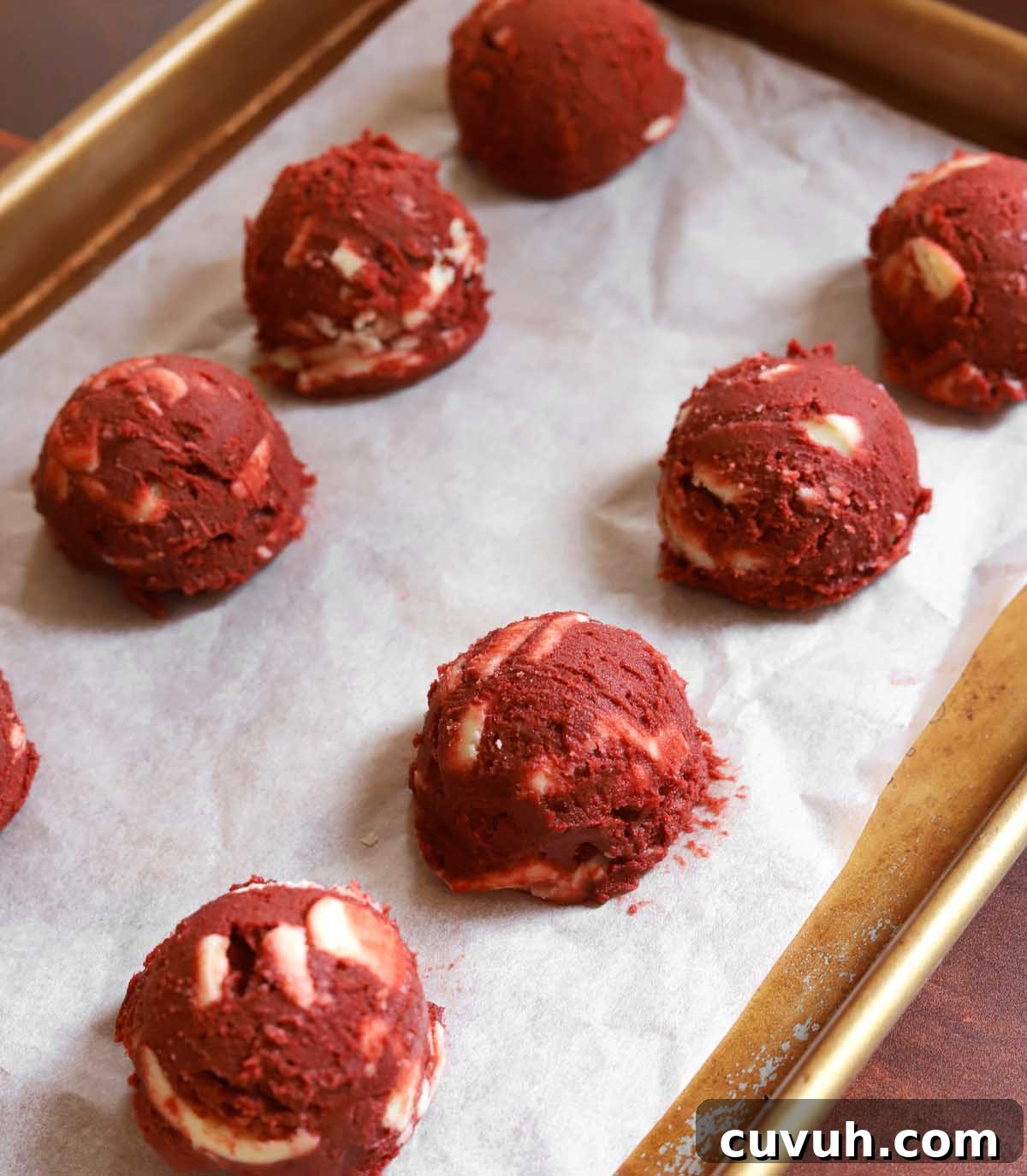 Decadent Red Velvet Cookies Recipe for Perfect Soft-Chewy Treats 8 red velvet cookie dough on parchment lined baking sheet before baking