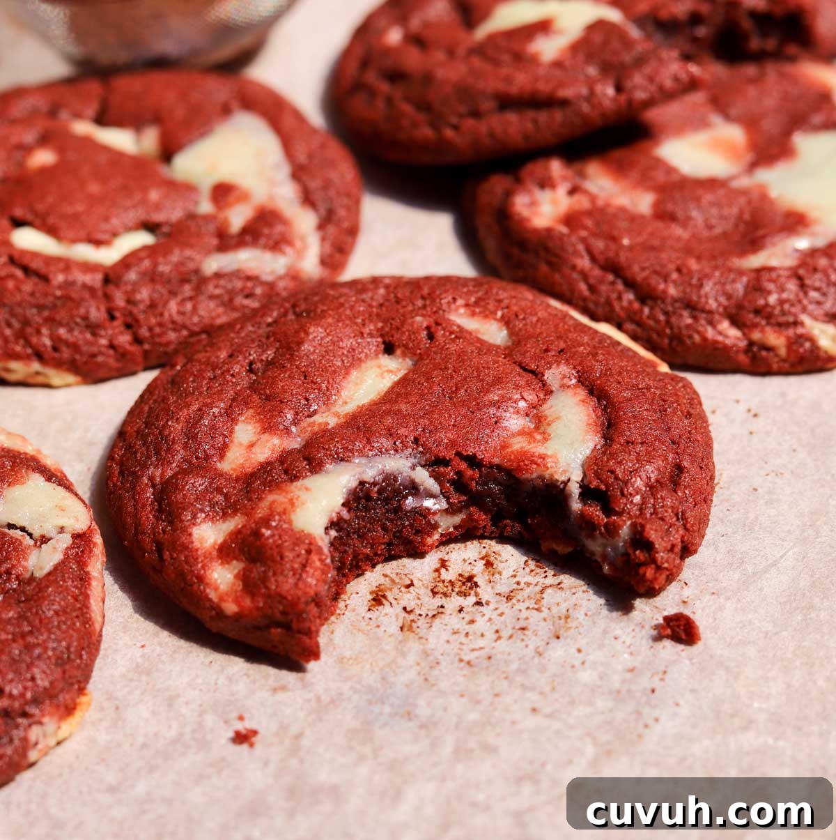Decadent Red Velvet Cookies Recipe for Perfect Soft-Chewy Treats 9 red velvet cookies with bite on baking sheet