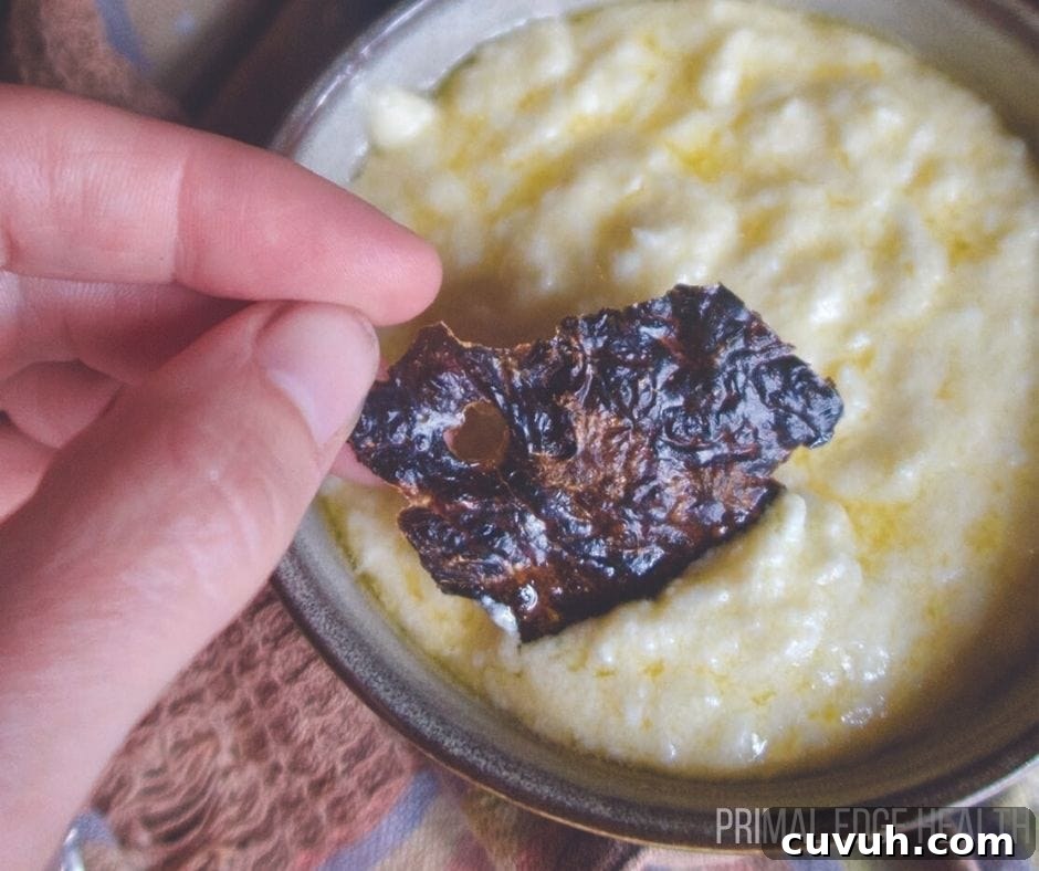 Liver Pâté Guide for Keto and Carnivore Diets: Recipes & Tips 5 A liver chip being dipped into a yellow sauce.