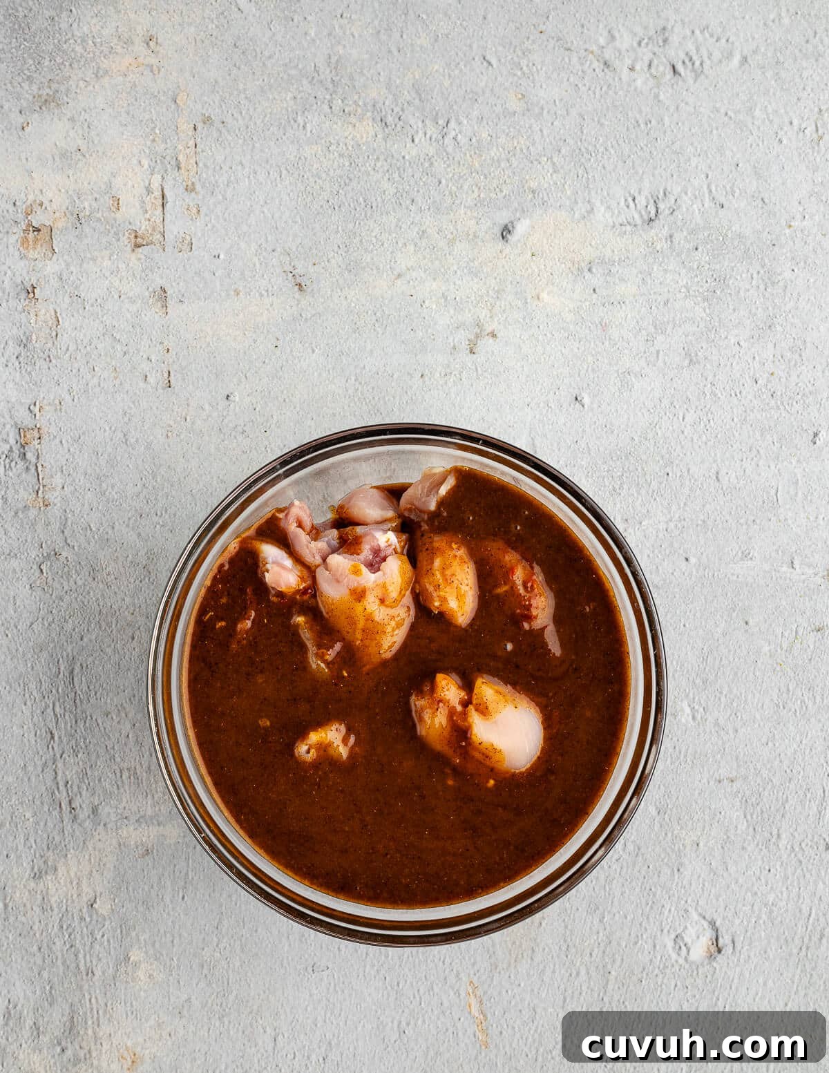 Honey Chipotle Glazed Chicken Thighs Recipe 6 a bowl of chicken thighs in a chipotle marinade.