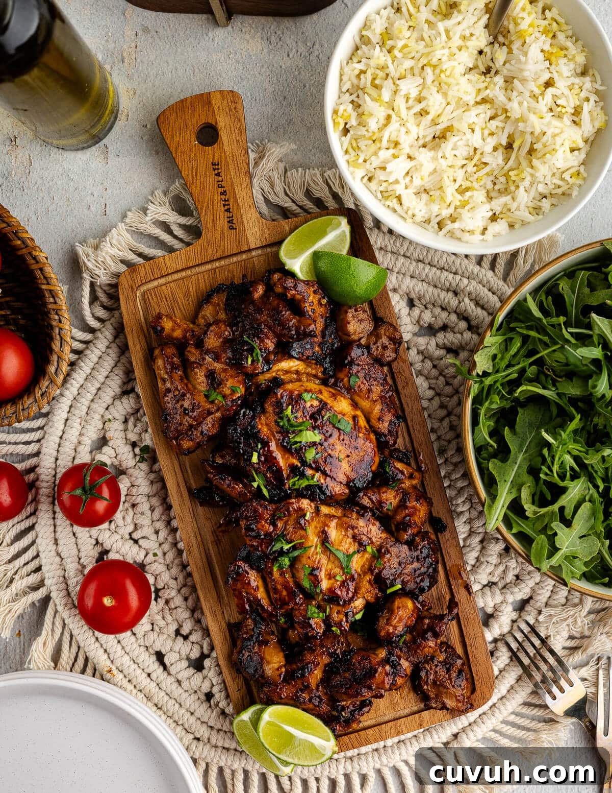 Honey Chipotle Glazed Chicken Thighs Recipe 9 honey chipotle chicken thighs on a cutting board with limes.