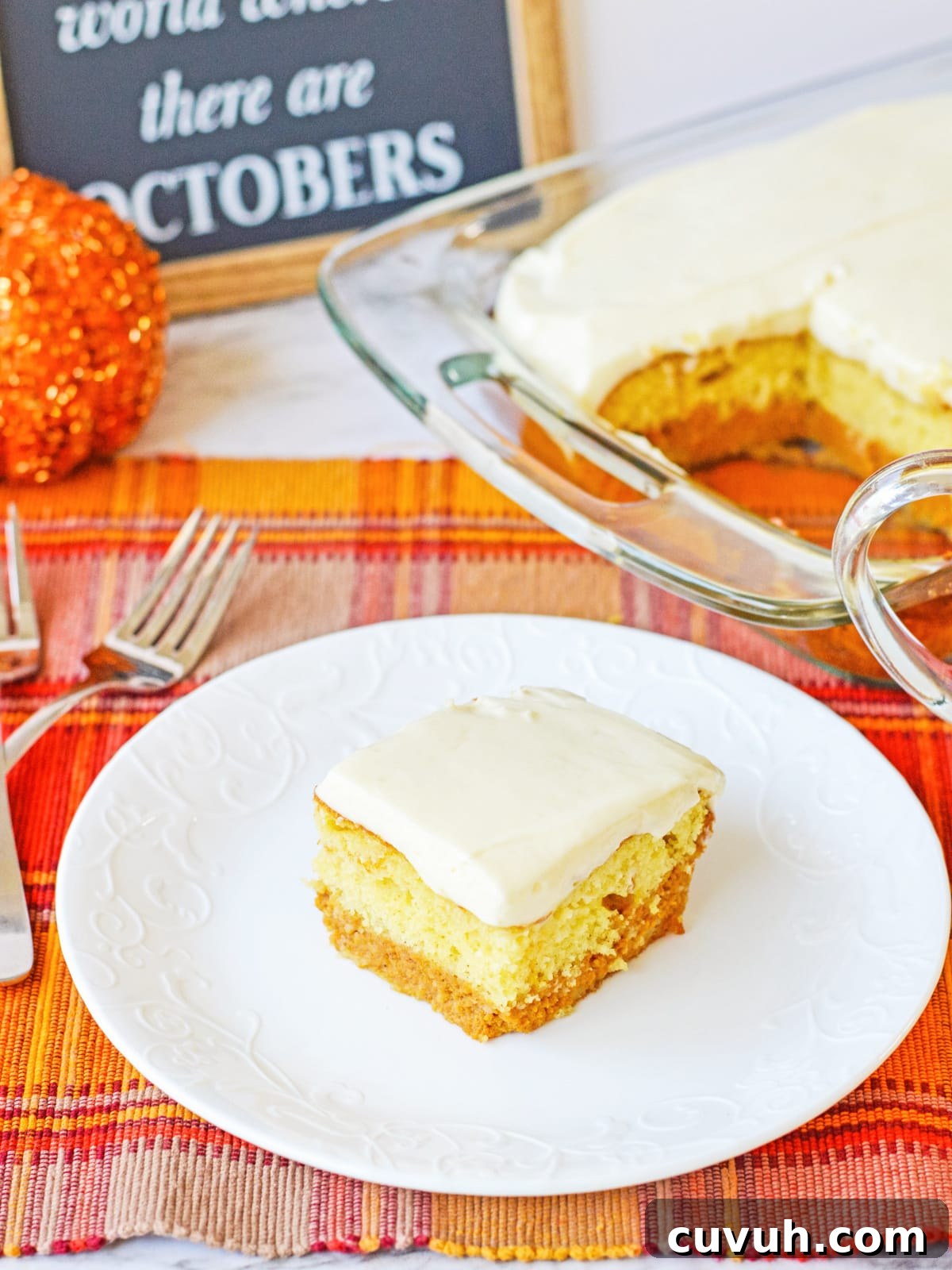 slice of pumpkin cake on a white plate with the pan in the background