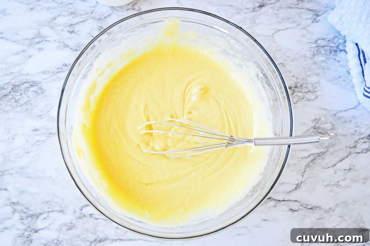 cake batter in a glass bowl with whisk