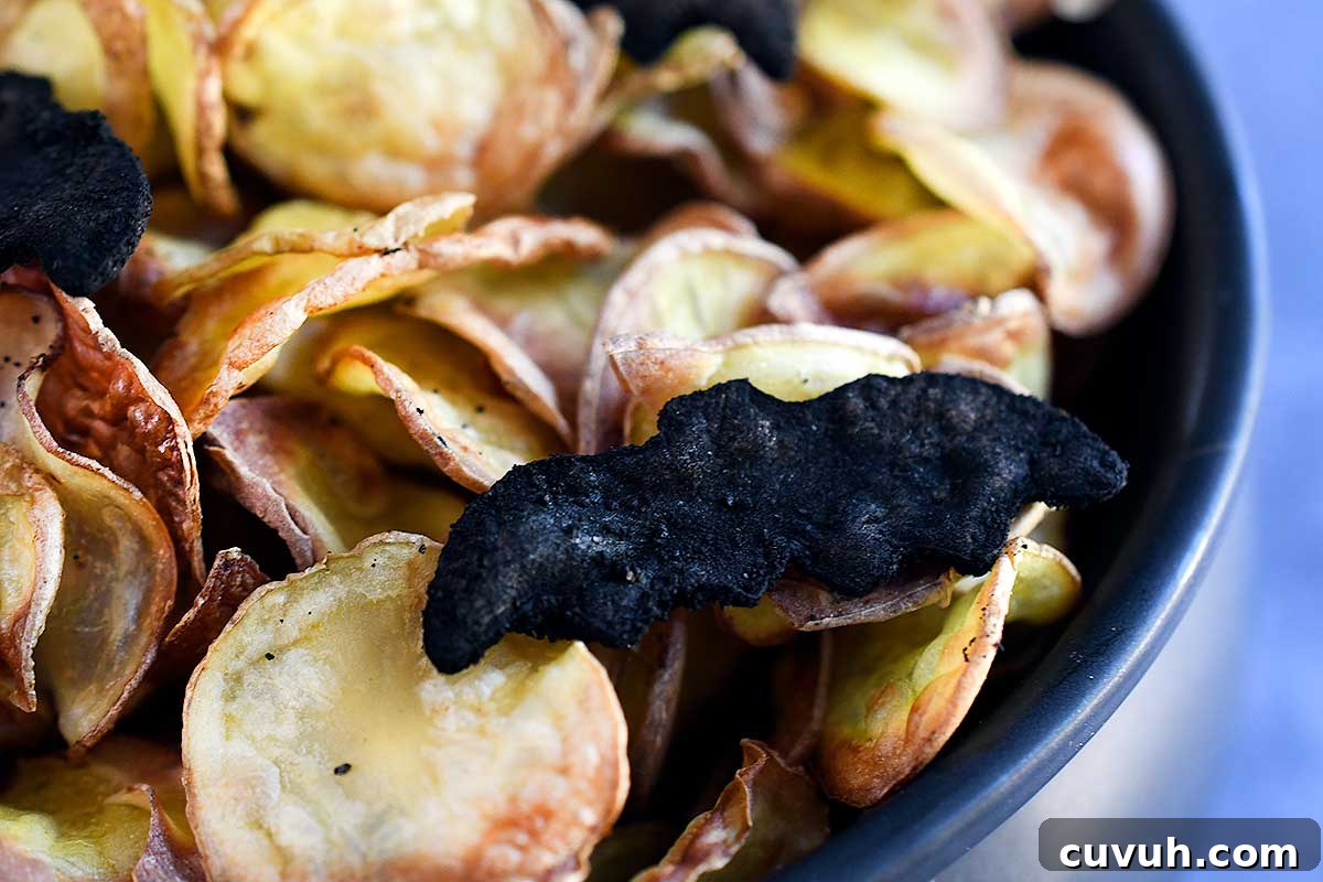 Bat chips coated in black seasoning mix (see in post for recipe) on top of yellow chips.