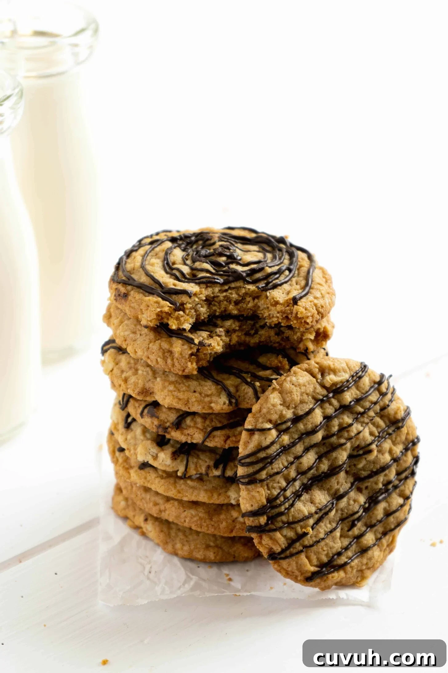 A stack of Oatmeal Chocolate Cookies with a bite taken.
