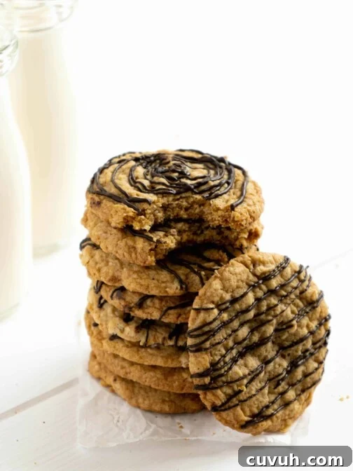 A stack of Oatmeal Chocolate Cookies with a bite taken.