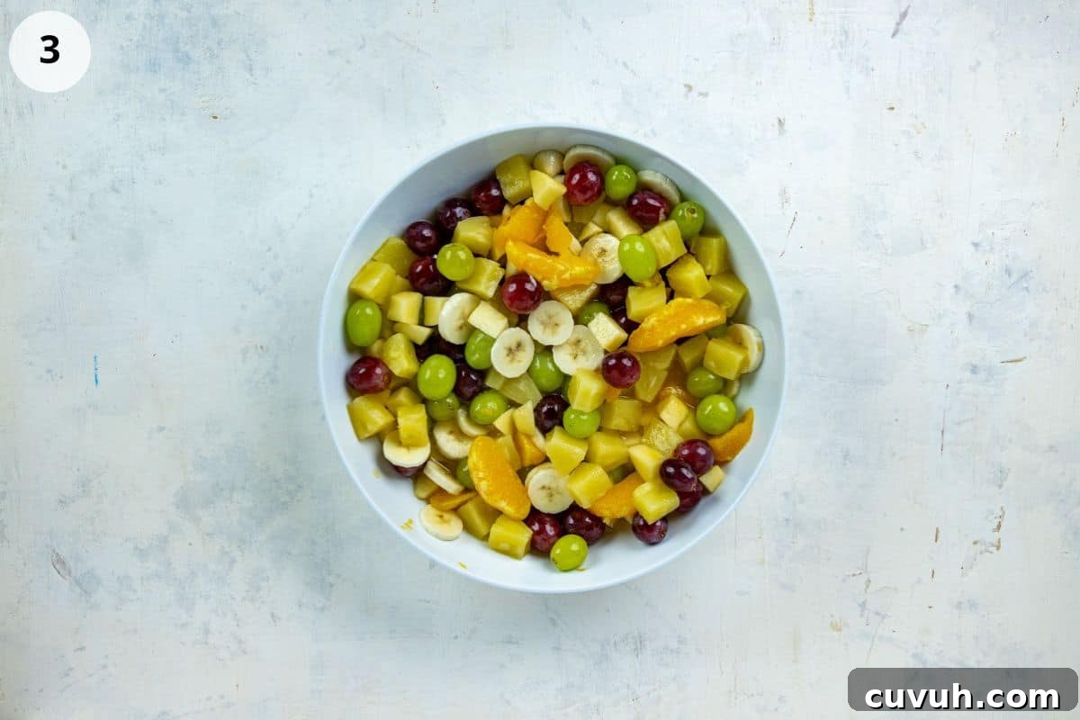 Sliced banana added to the fruit salad.