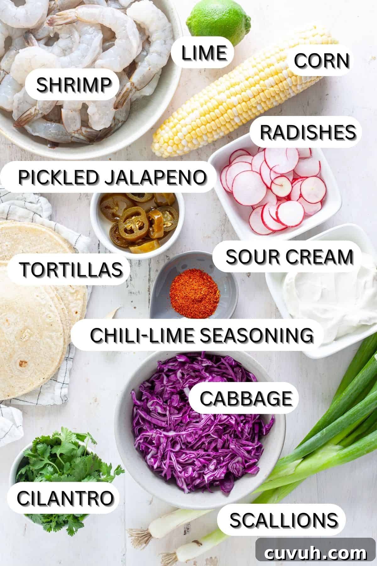 Ingredients for chili lime shrimp tacos on a white table.