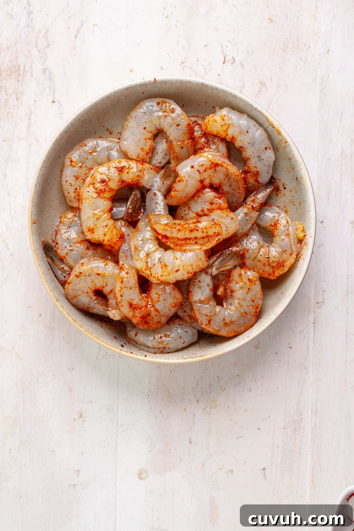 Shrimp marinating with oil, garlic and chili lime seasoning.