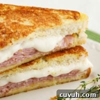 Italian Style Monte Cristo with honey mustard thyme sauce cut in half.