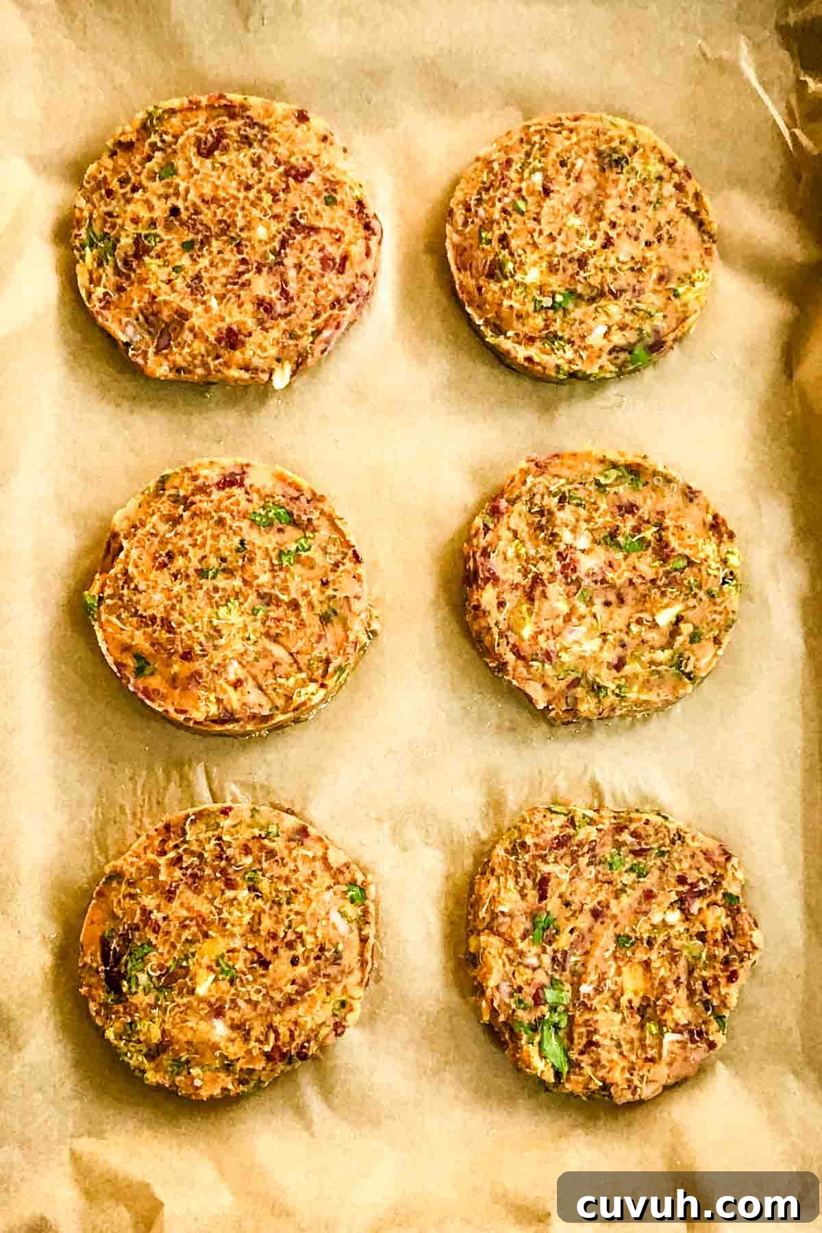 Sweet Potato and Black Bean Burger Recipe for Flavorful Veggie Meals 3 6 veggie burger patties on a parchment lined baking tray.