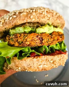 Sweet Potato and Black Bean Burger Recipe for Flavorful Veggie Meals 6 Veggie burger in a bun with lettuce, ketchup and guacamole.