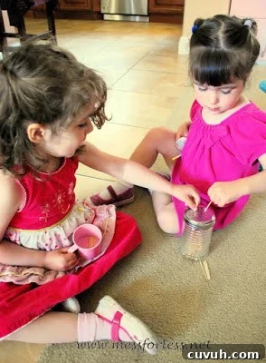 children placing tooth picks in shaker