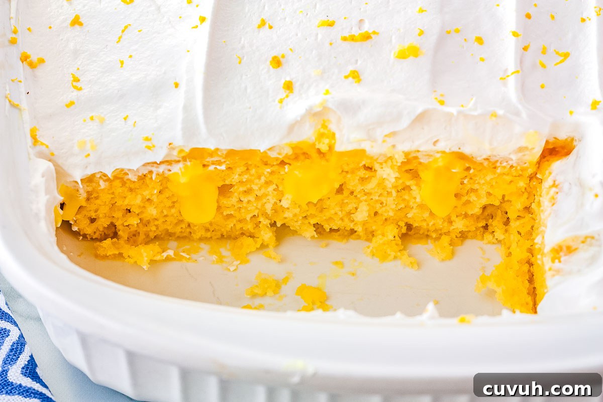 Moist Lemon Poke Cake with Zesty Citrus Glaze 3 A close up interior shot of the finished lemon poke cake recipe.