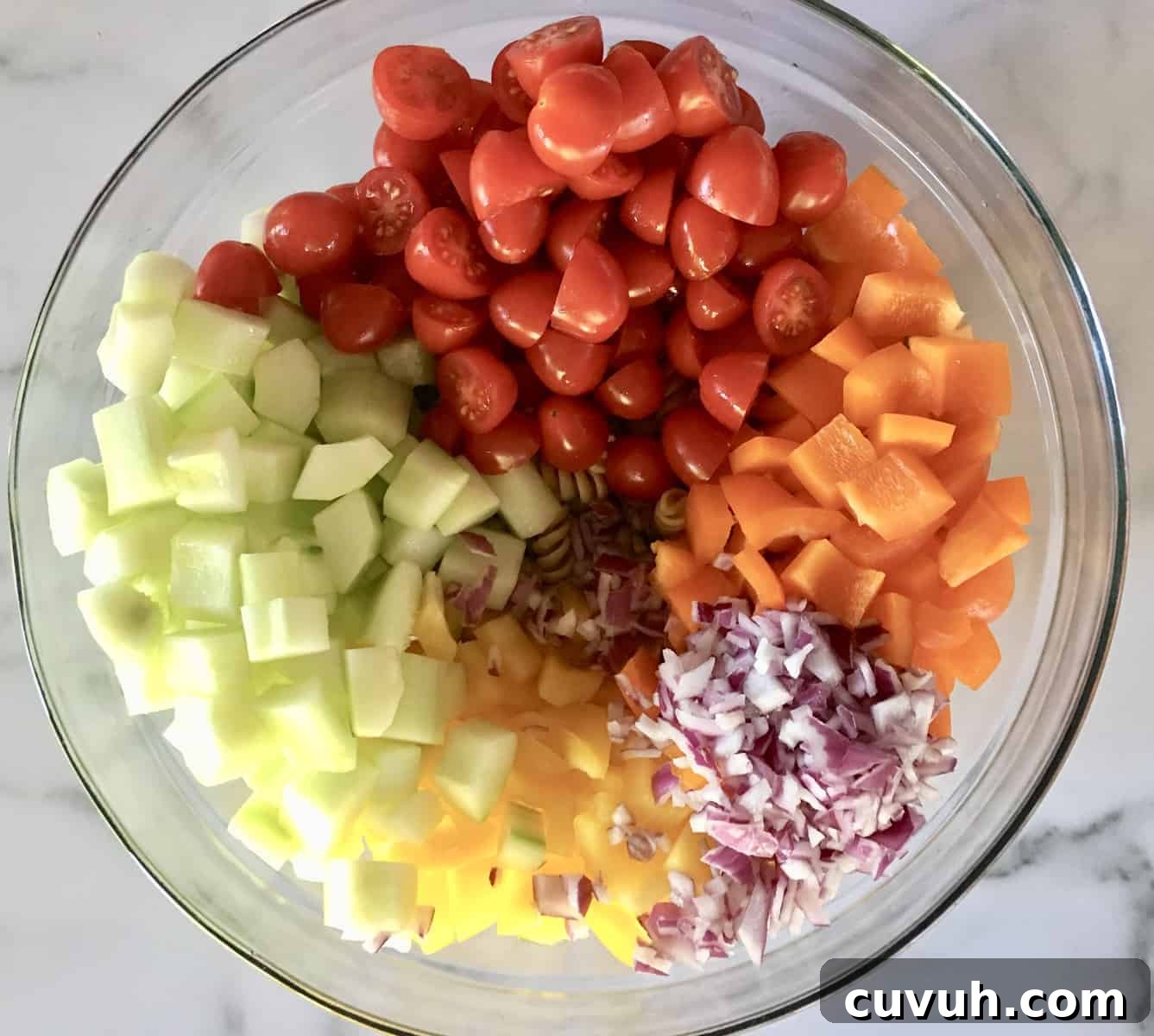 Whole Wheat Greek Pasta Salad with Feta & Olives 4 glass bowl full of rotini pasta, bell peppers, cucumbers, tomatoes, and red onions.