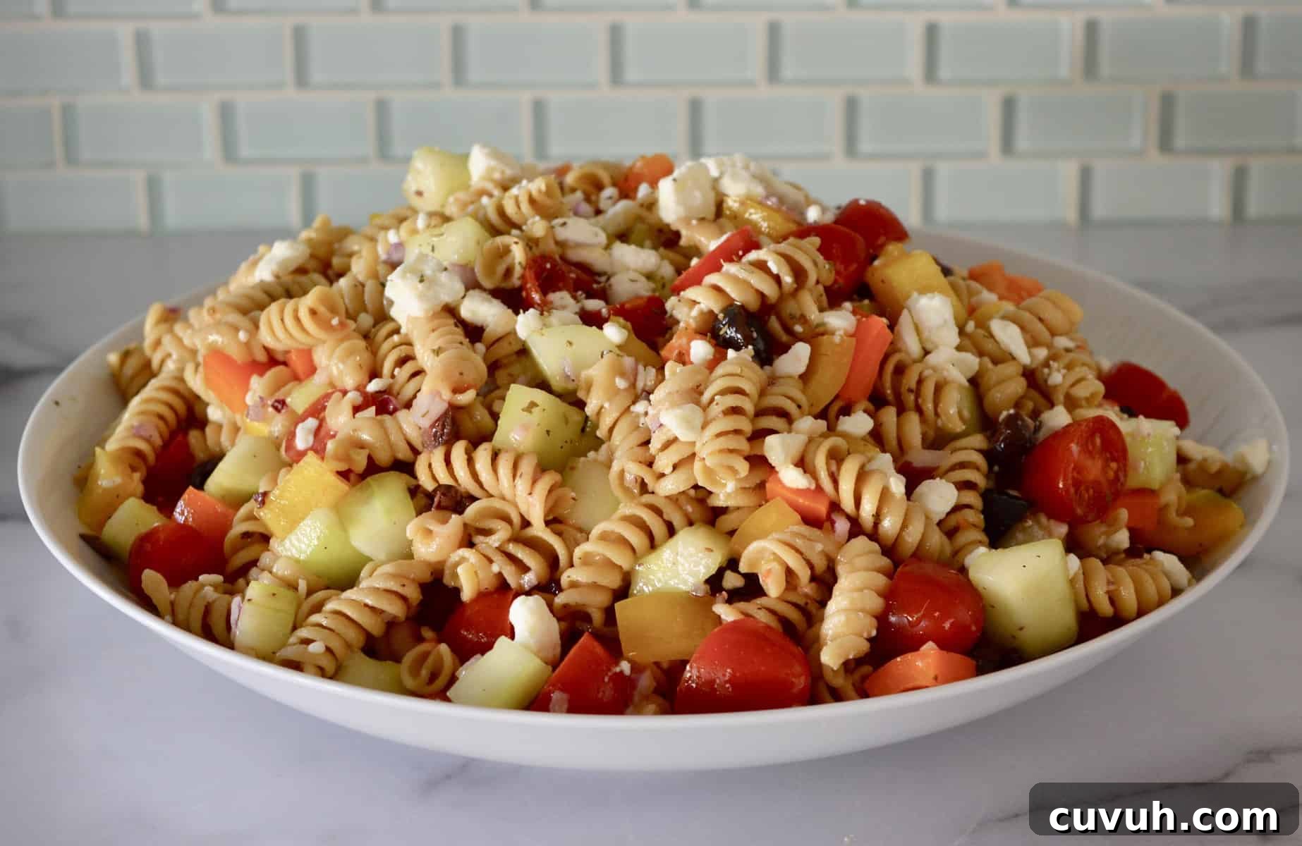 Whole Wheat Greek Pasta Salad with Feta & Olives 6 Whole Wheat Greek Pasta Salad in a white bowl.