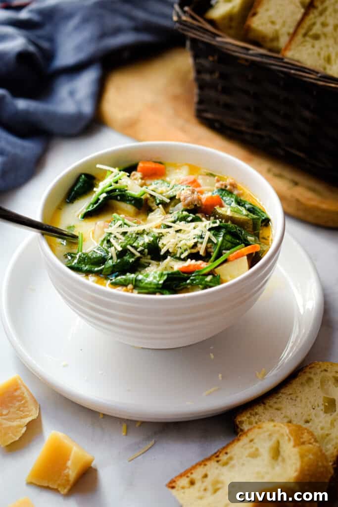 Instant Pot Zuppa Toscana: Sausage and Spinach Soup Recipe 2 The Instant Pot Zuppa Toscana is in a bowl on a plate with a bread basket in the background