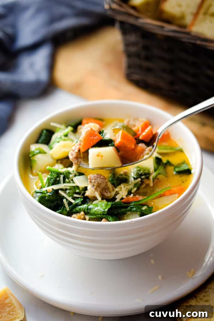 Instant Pot Zuppa Toscana: Sausage and Spinach Soup Recipe 5 A spoon is lifting some of the soup out of the bowl