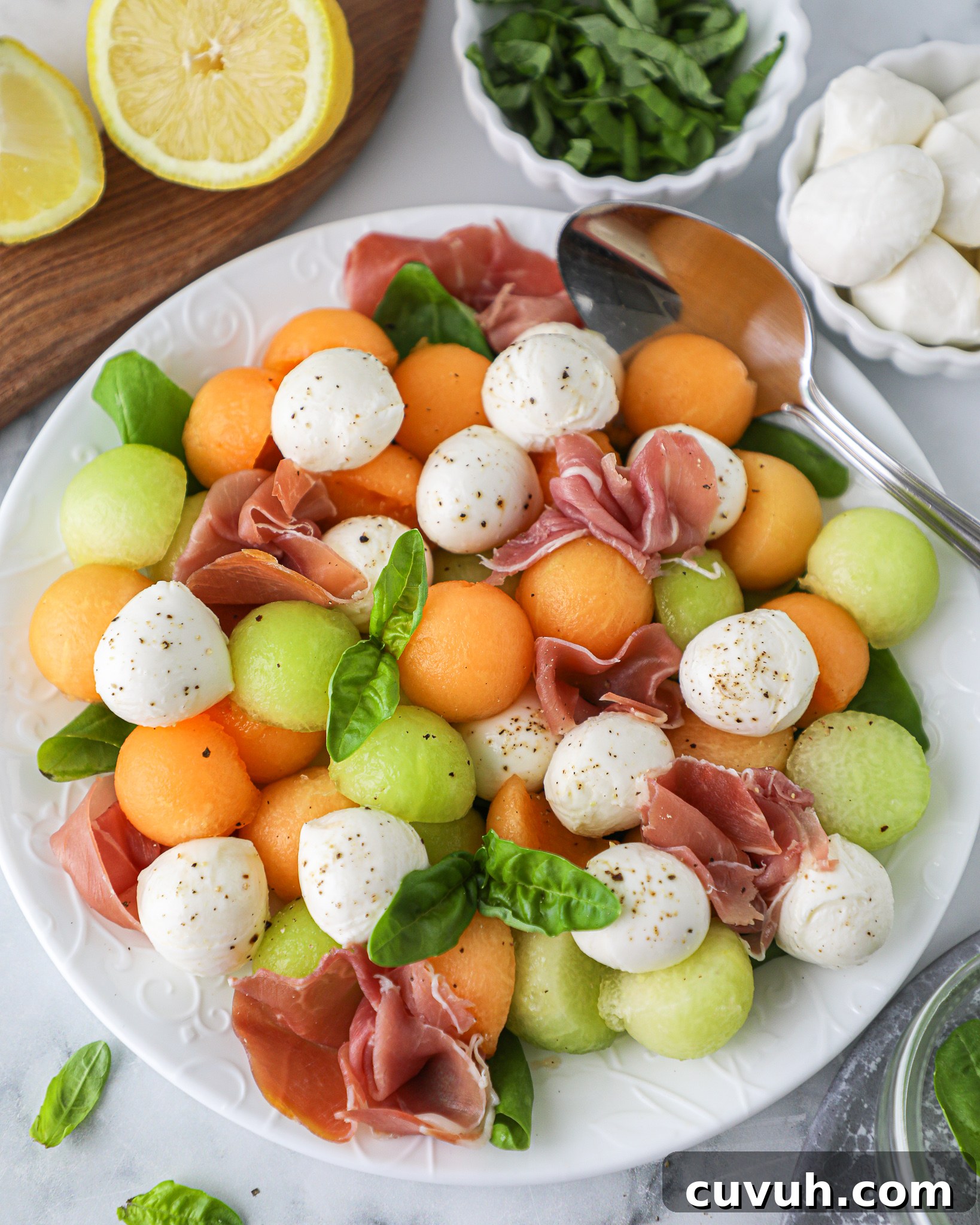 A light and refreshing summer salad made with summer melons, mozzarella balls, prosciutto and fresh basil! It's so easy to make and pairs well with everything!