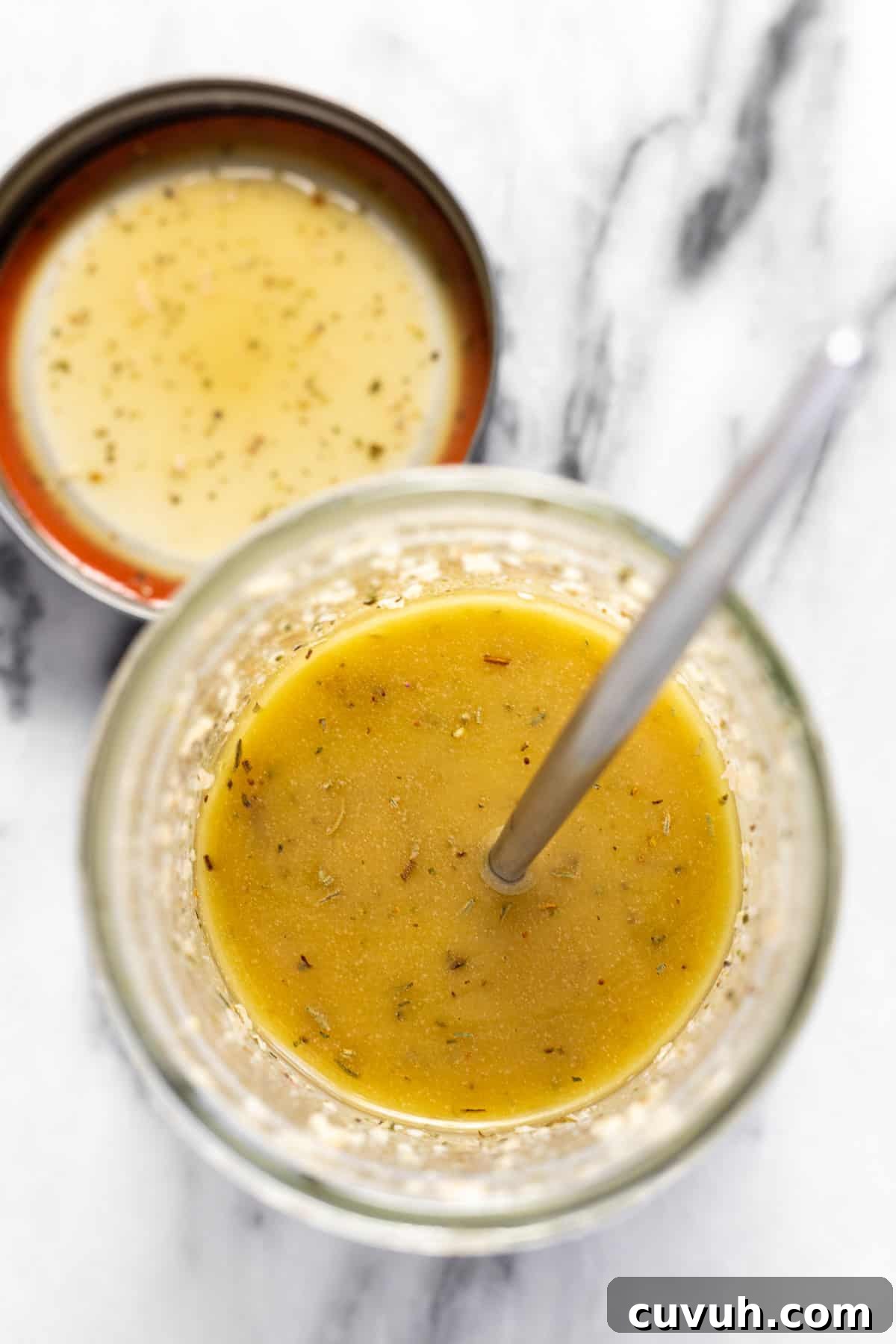 5-Minute Red Wine Vinaigrette Recipe for Fresh Salads 2 Overhead shot of a wide mouth mason jar filled with homemade red wine vinaigrette with a spoon.