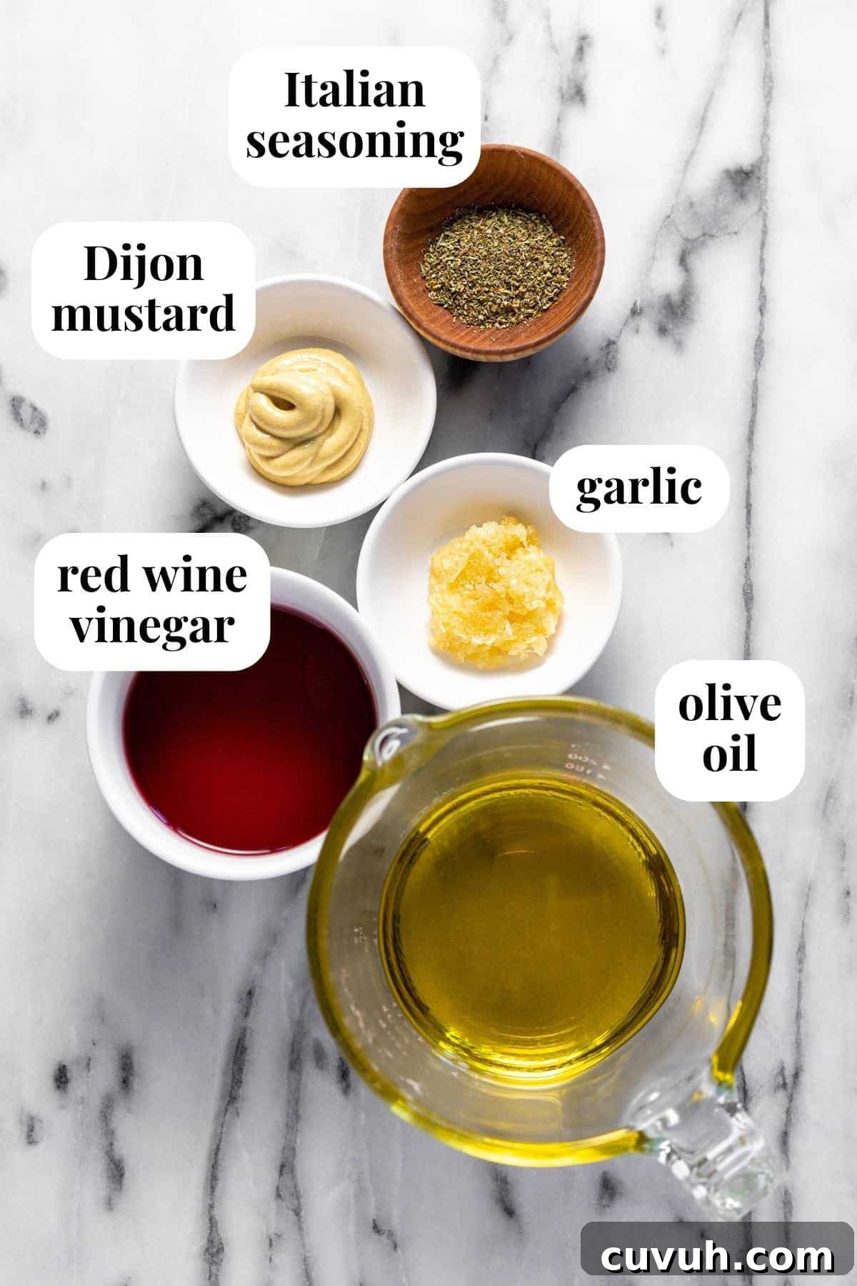 5-Minute Red Wine Vinaigrette Recipe for Fresh Salads 3 White marble counter top with bowls of ingredients to make red wine vinaigrette.