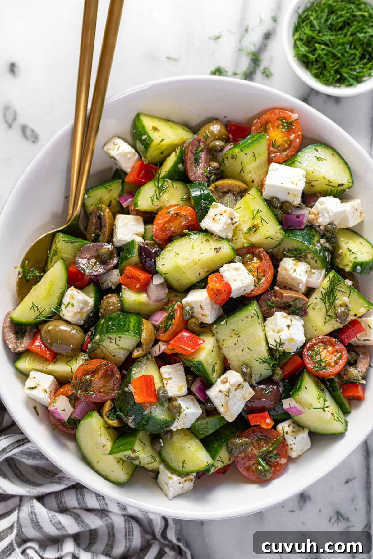 5-Minute Red Wine Vinaigrette Recipe for Fresh Salads 4 Large white bowl filled with homemade Greek salad tossed in a vinaigrette.