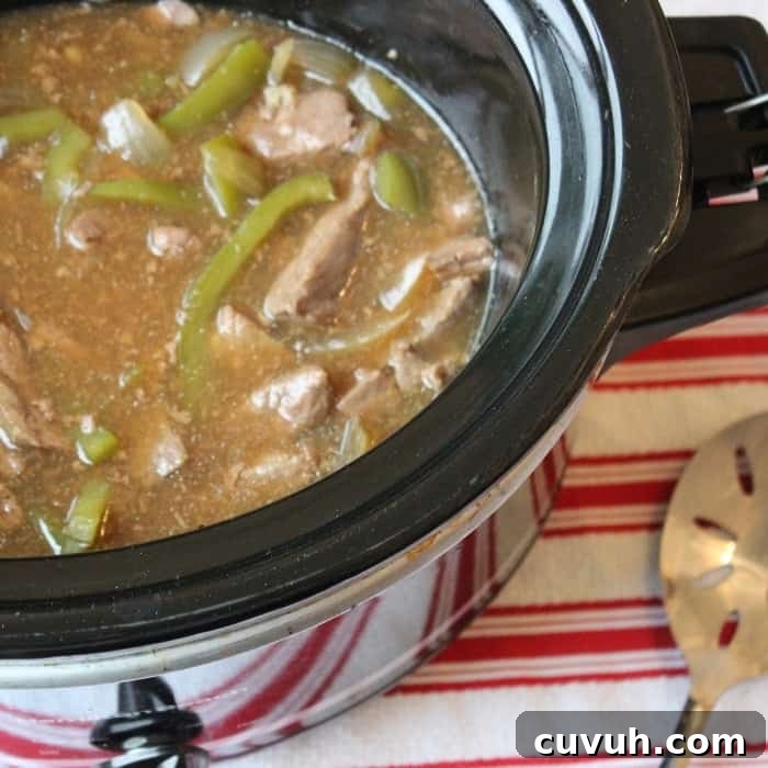Slow cooker pepper steak that is melt in your mouth delicious. The best pepper steak recipe with tender and juicy steak, onion and peppers in every bite #slowcooker #peppersteak #easydinner pepper steak slow cooker recipe
