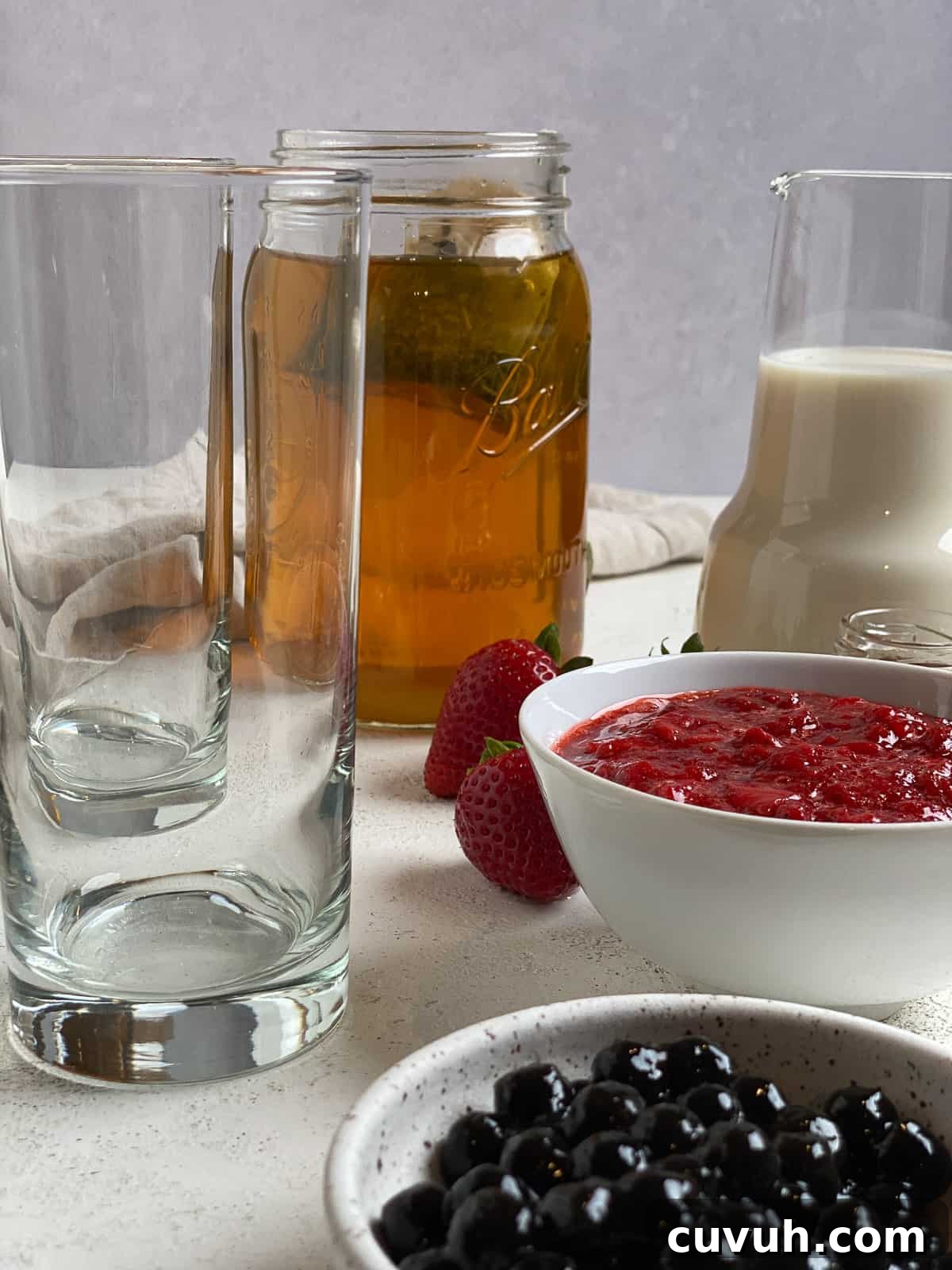 ingredients for Strawberry Boba Tea on a white surface