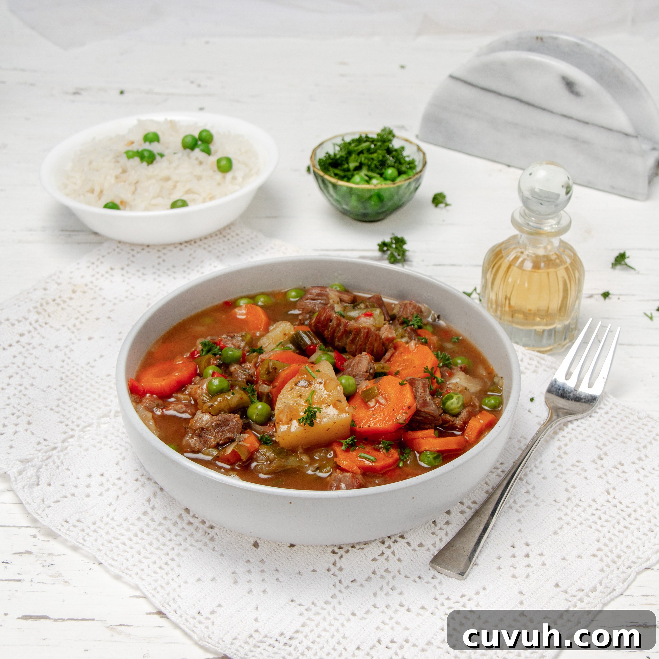 Mulligan Stew Recipe: Hearty One-Pot Comfort Meal 2 Hearty and comforting Milligan Stew in a bowl with a bowl of fresh herbs and rice on the side.