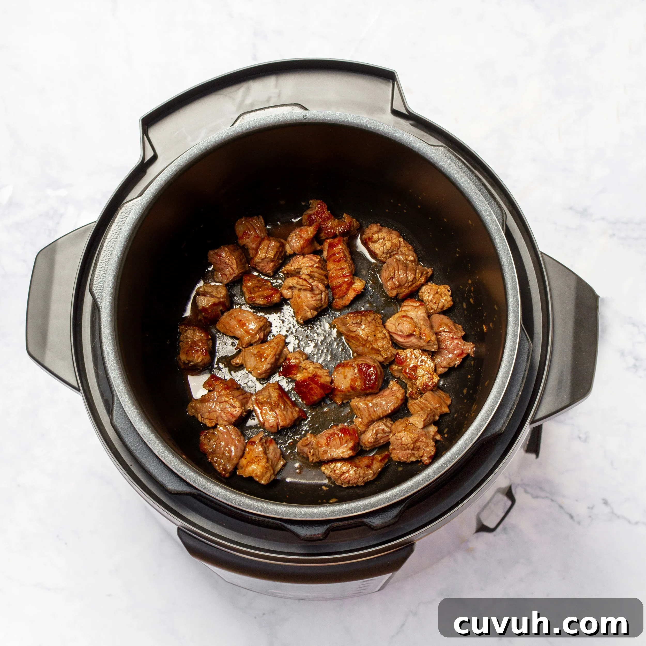 Mulligan Stew Recipe: Hearty One-Pot Comfort Meal 5 Seasoned meat searing in the soup pot.