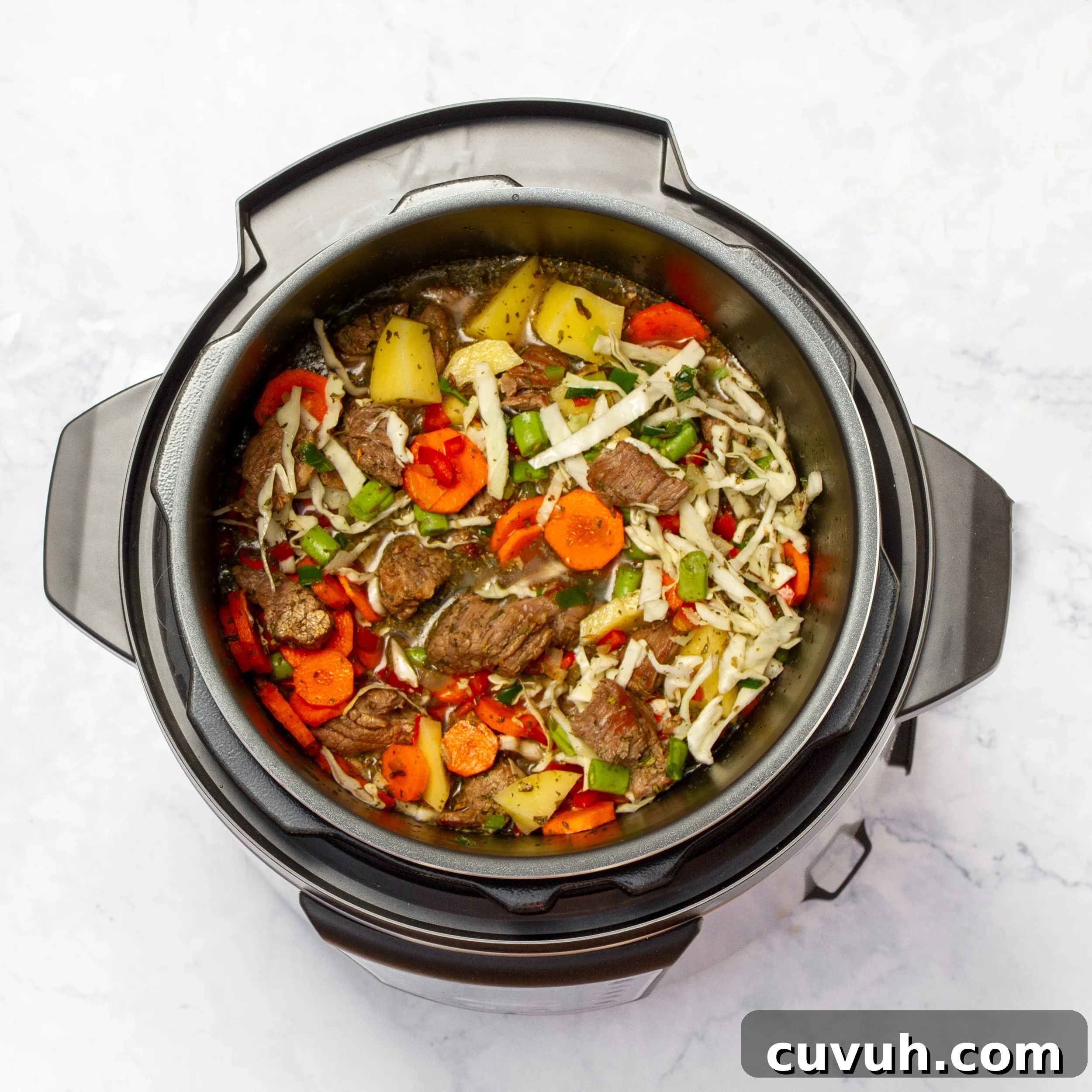 Mulligan Stew Recipe: Hearty One-Pot Comfort Meal 7 All vegetables, seared meat, and broth added to the pressure cooker.