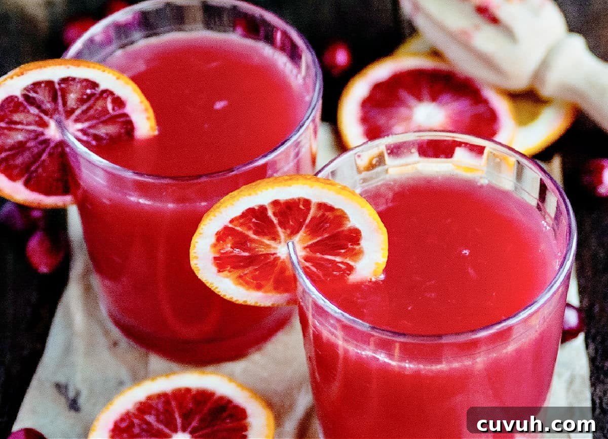Madras Cocktail Recipe: How to Make the Classic Cranberry Vodka Drink 5 Short glasses with madras cocktail and blood orange slices.