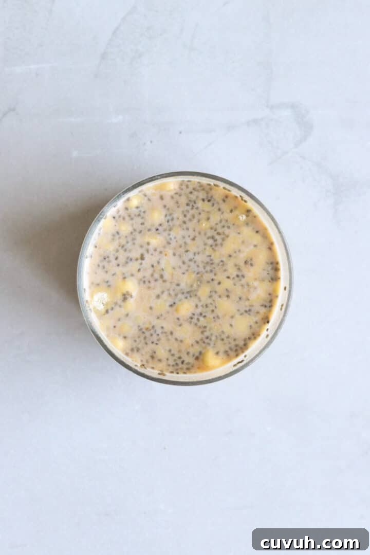 Overhead photo of a glass jar with un-set pumpkin chia seed pudding
