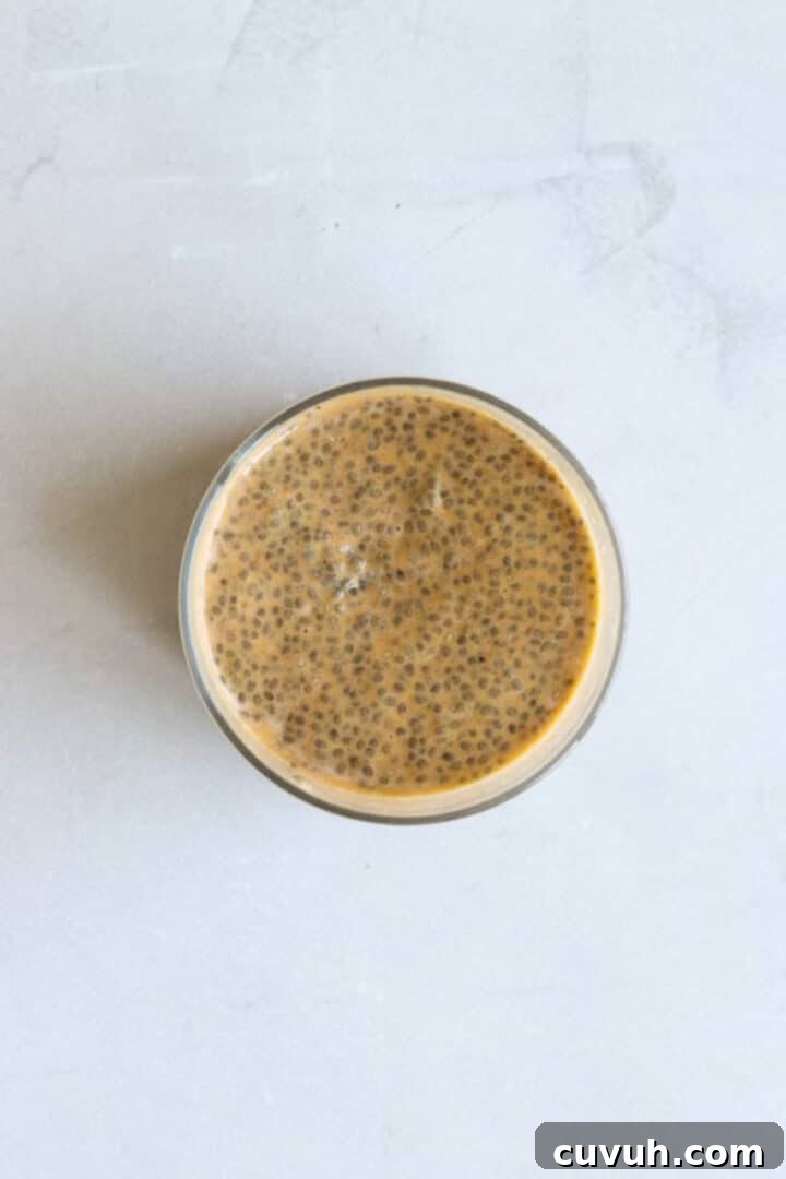 Overhead photo of a glass jar containing finished pumpkin chia seed pudding