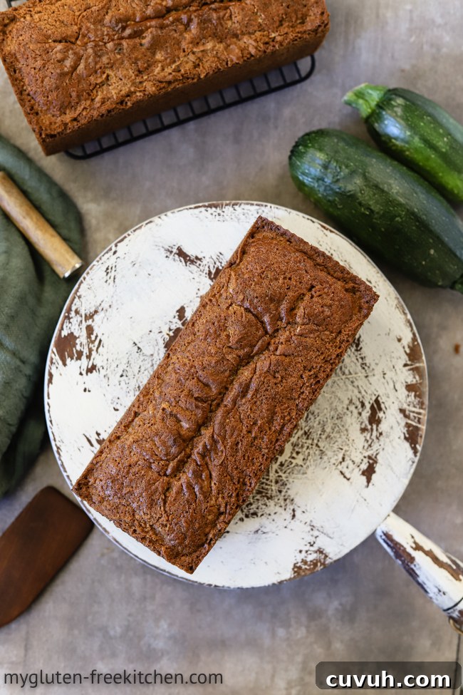 two loaves of gluten-free zucchini bread plus a few zucchini laying around them
