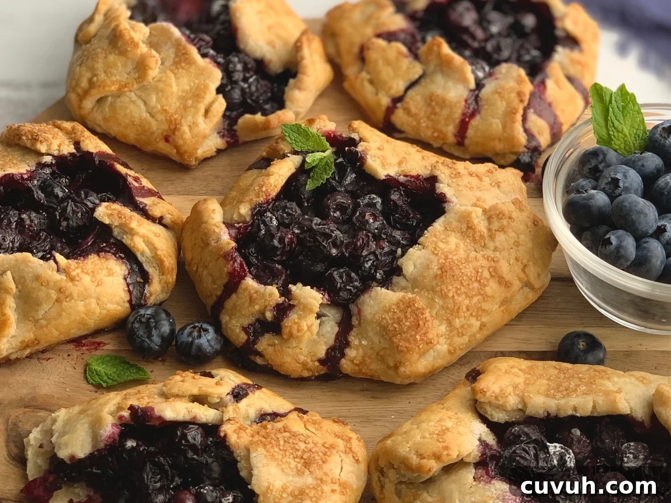 Patriotic 4th of July Desserts to Impress Your Guests 10 A flat pie dough with sides to keep a blueberry filling inside. With a garnish of fresh mint on top.