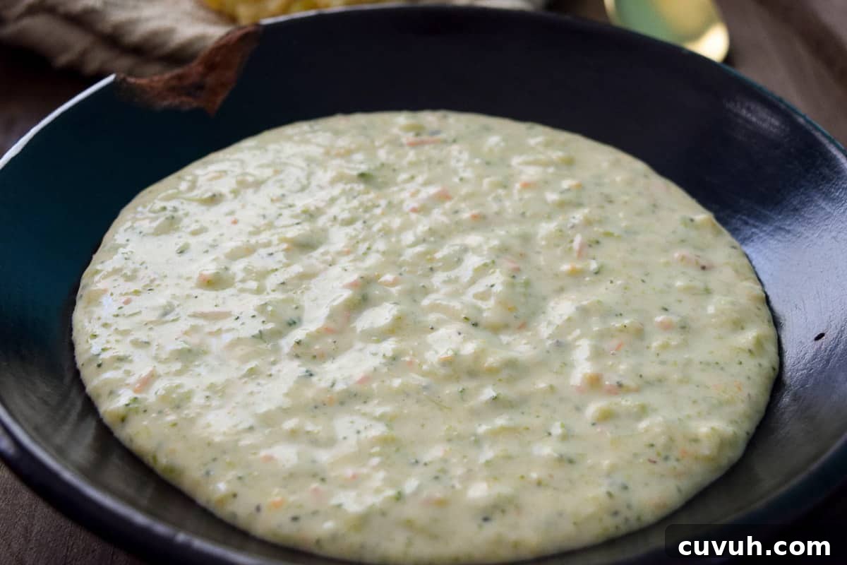 Broccoli Cheddar Soup in black bowl up close view