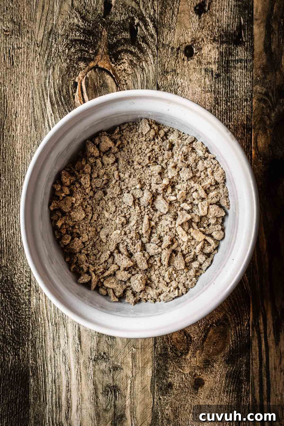 Apple and Blackberry Crumble Recipe for Perfect Autumn Dessert 4 A bowl filled with crumble topping.