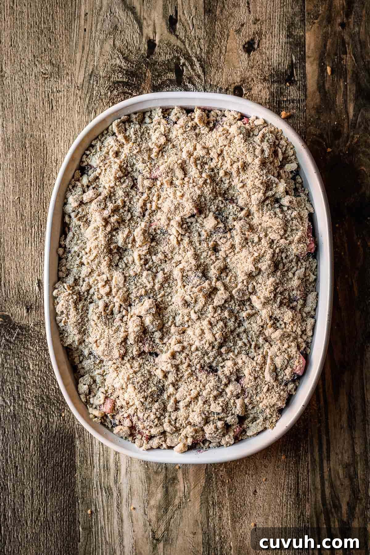 Apple and Blackberry Crumble Recipe for Perfect Autumn Dessert 7 A baking dish filled with fruit and covered with crumble topping.