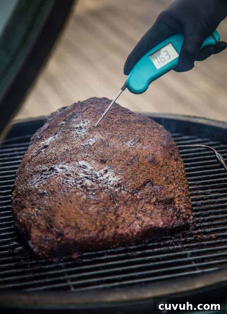 Taking temperature of brisket for burnt ends.