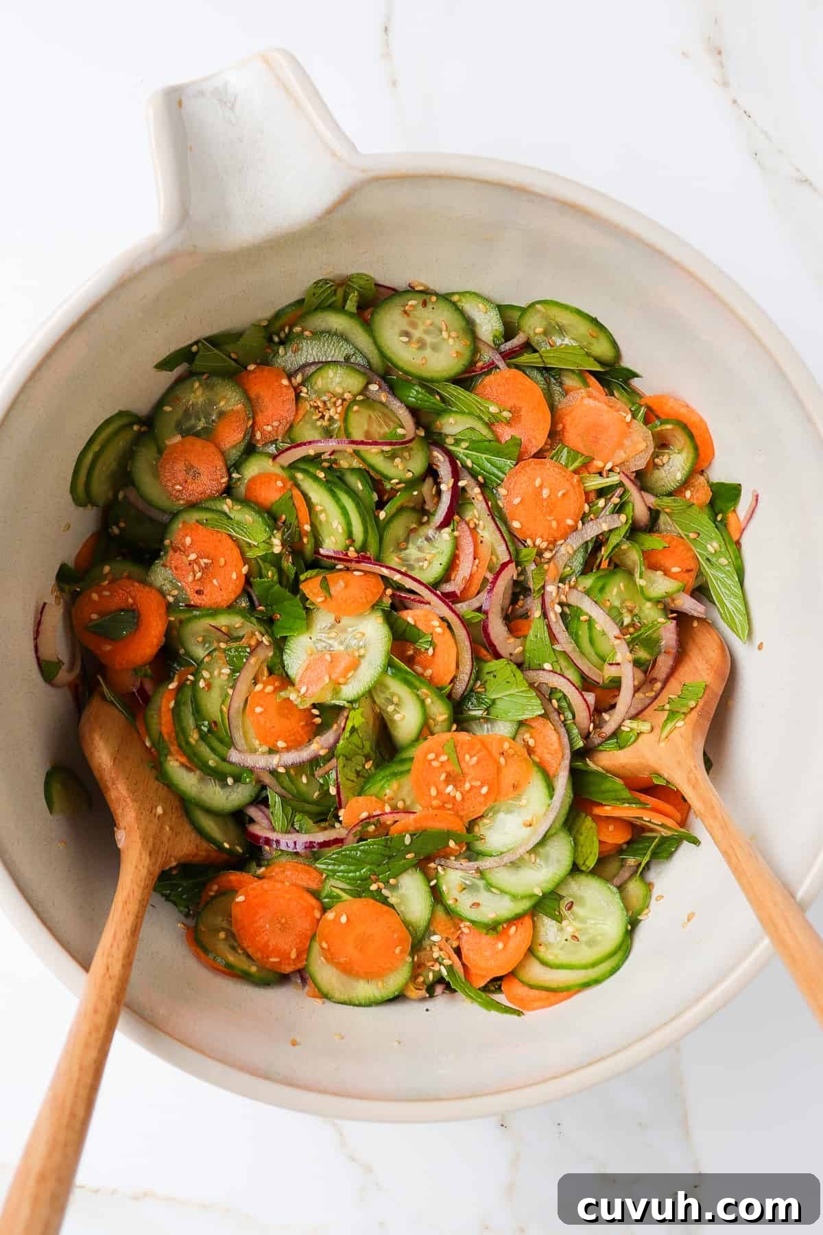 Sesame Carrot and Cucumber Salad with Tangy Dressing 3 Cucumber carrot salad in mixing bowl.