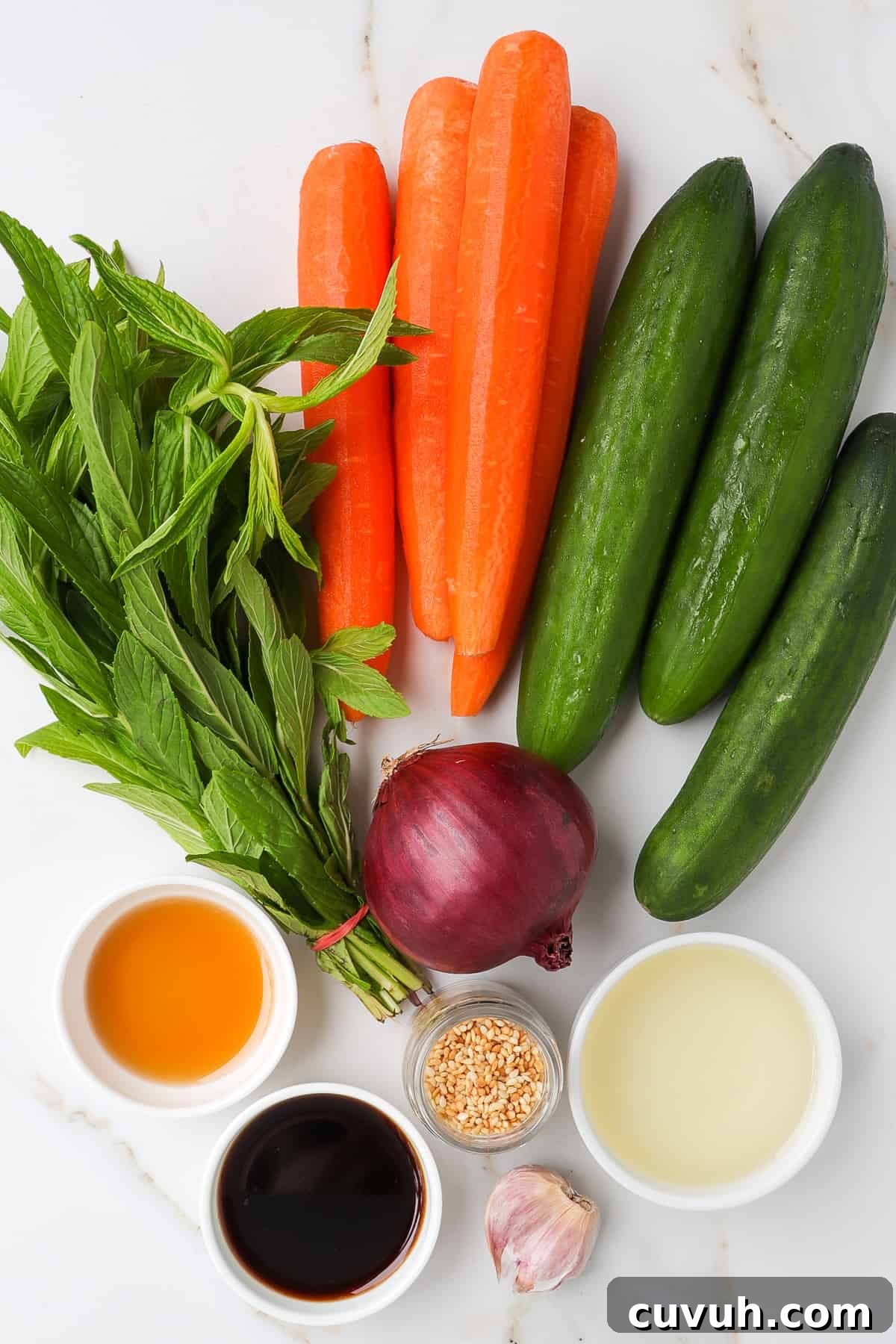 Sesame Carrot and Cucumber Salad with Tangy Dressing 4 Ingredients shown to make the cucumber carrot salad.